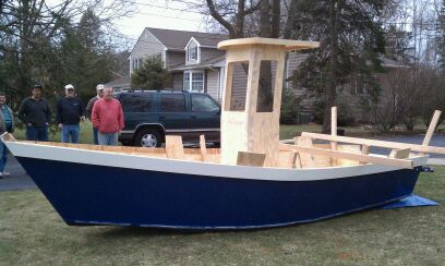 A blue and white customer-built cabin skiff