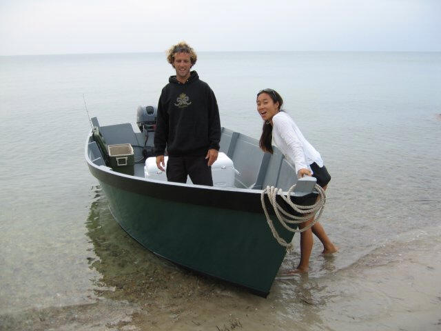 A customer-built Lady Bug skiff at the water's edge